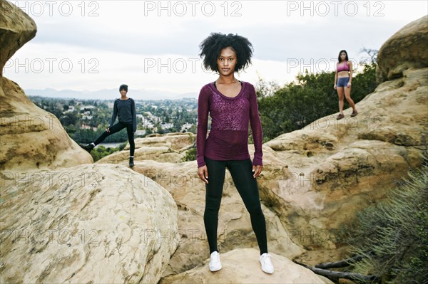 Portrait of serious women posing on rock formation