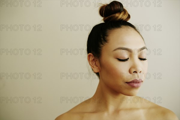 Portrait of Asian woman with eyes closed