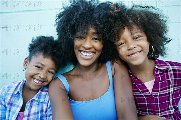 Portrait of smiling mother and daughters