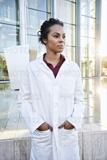 Portrait of serious Mixed Race doctor outdoors at hospital