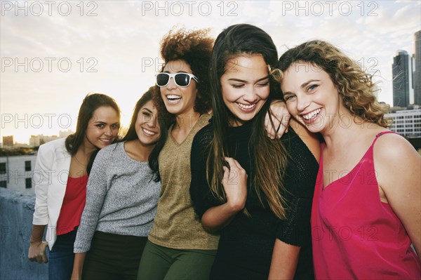 Portrait of smiling women on urban rooftop