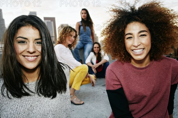 Portrait of smiling women on urban rooftop