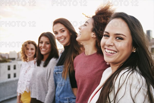 Portrait of smiling women on urban rooftop
