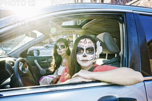 Women in car wearing skull face paint