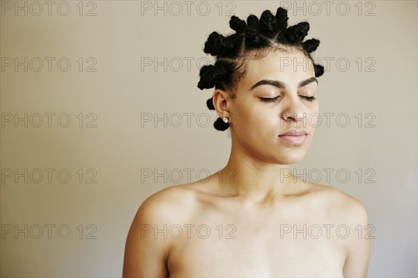 Portrait of Mixed Race woman with eyes closed