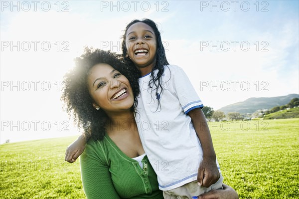 Portrait of smiling mother and mixed race daughter