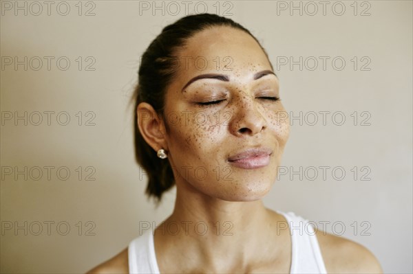 Close up of mixed race woman with eyes closed
