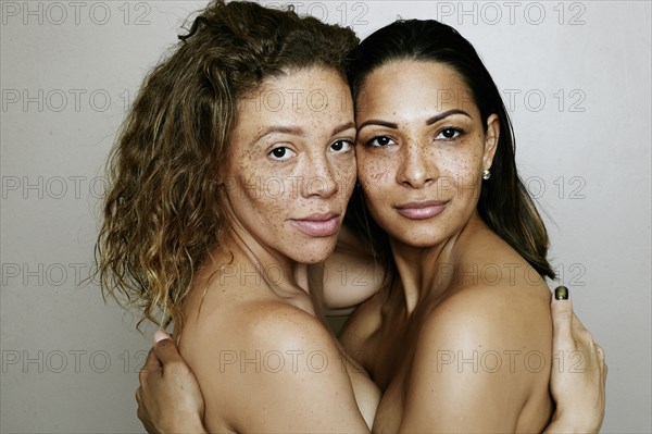 Close up of mixed race women hugging