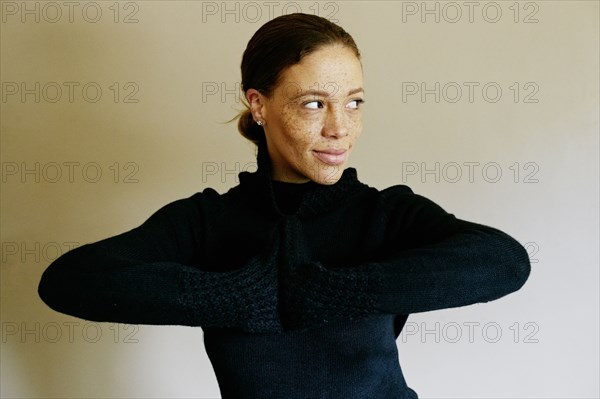 Mixed race woman wearing sweater looking away