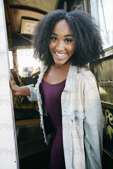 Portrait of smiling mixed race woman on bus