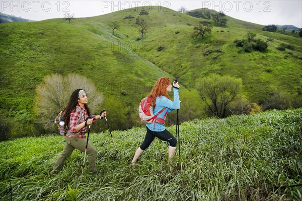 Women hiking with walking sticks