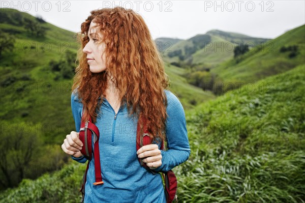 Caucasian woman hiking with backpack