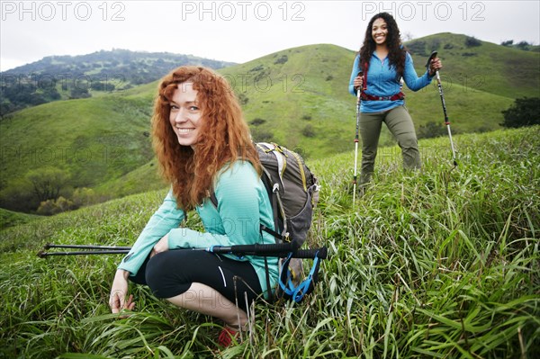 Portrait of smiling women hiking with walking sticks