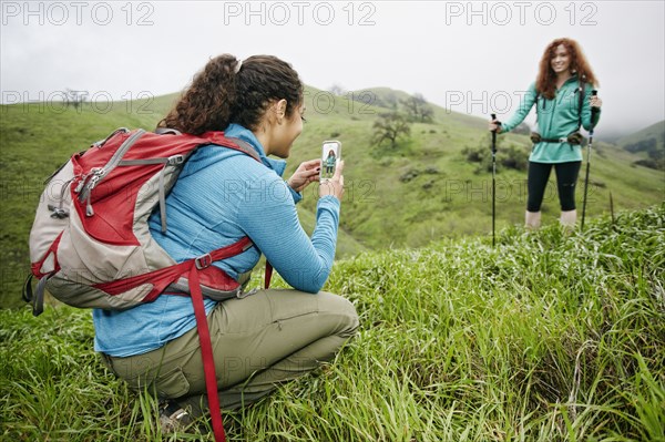 Hyper photographing friend with cell phone