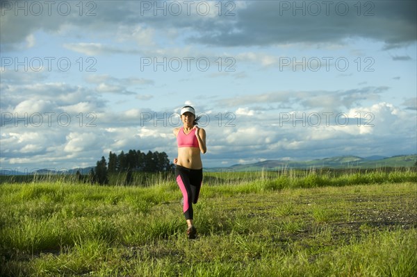 Japanese woman running in field