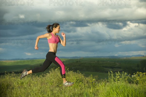 Japanese woman running in field