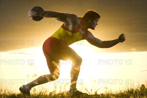 Caucasian athlete preparing to throw discus