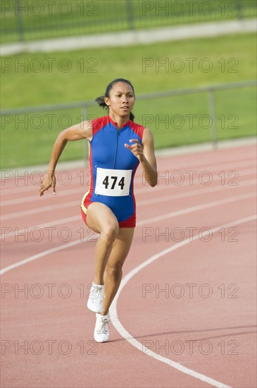 Mixed race runner running on racetrack