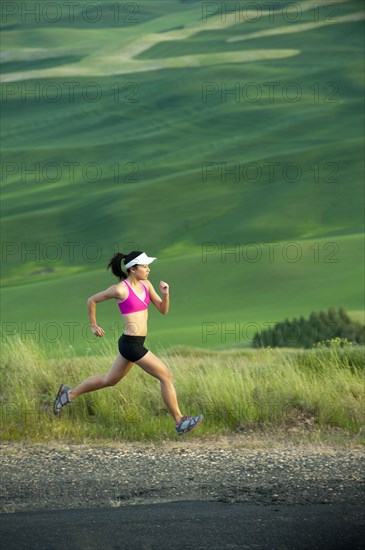 Mixed race runner running in countryside