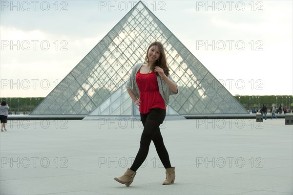 Caucasian woman walking  at the Louvre