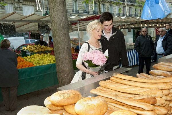 Caucasian couple shopping for bread at market