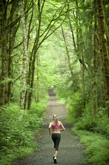 Caucasian woman running on remote path