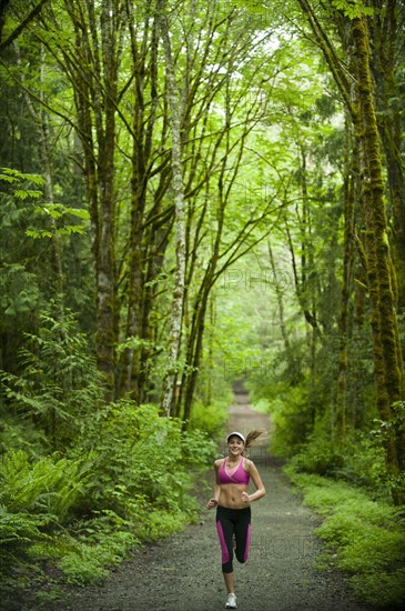 Caucasian woman running on remote path