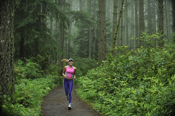 Caucasian woman running on remote path