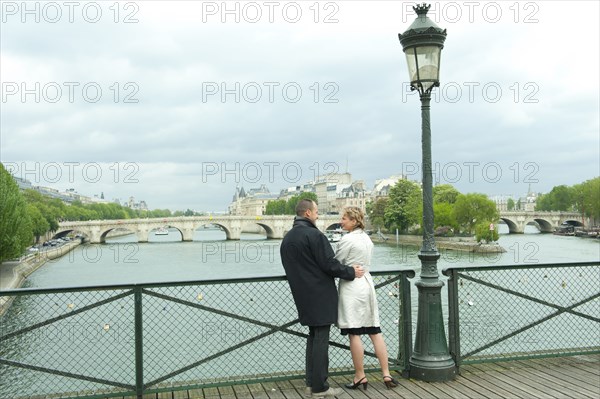 Caucasian couple talking on bridge