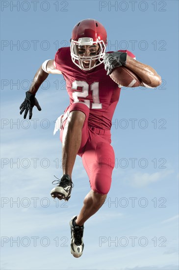 African American football player running with football