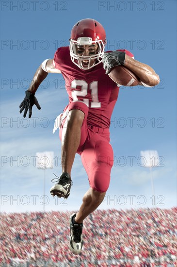 African American football player running with football