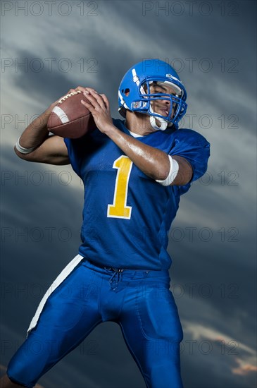 Black football player about to throw football