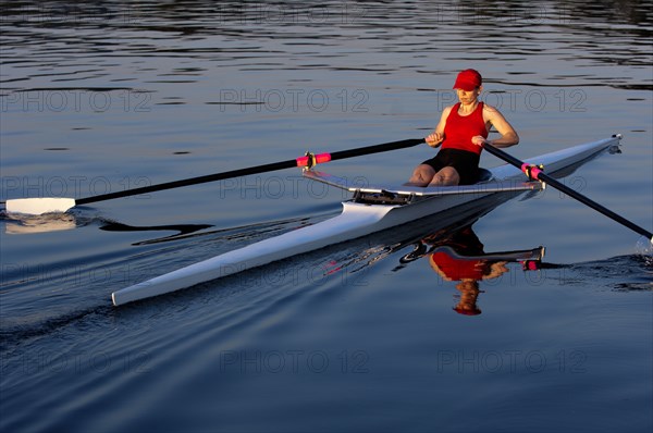 Person rowing sculling boat on river