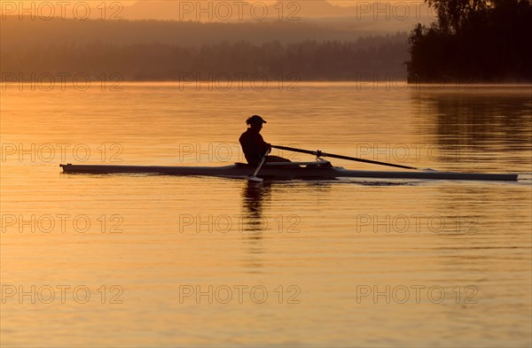 Person rowing sculling boat on river