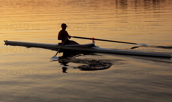 Person rowing sculling boat on river