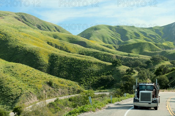 Semi-truck driving on remote highway