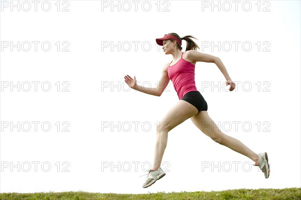 Mixed race teenager running outdoors