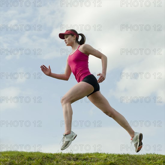 Mixed race teenager running outdoors