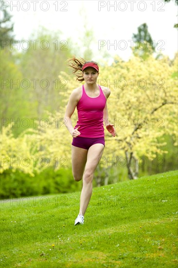 Mixed race woman running in park