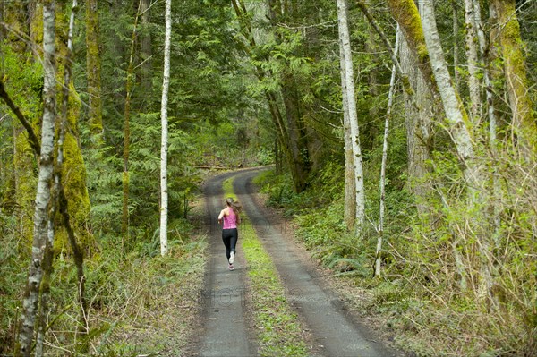 Mixed race runner training on remote road