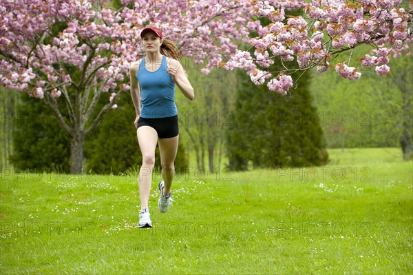 Mixed race runner jogging across field