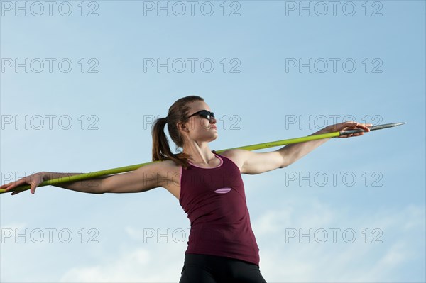 Caucasian athlete holding javelin