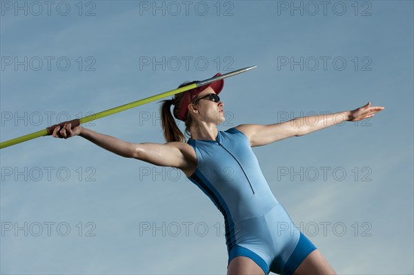 Caucasian athlete throwing javelin