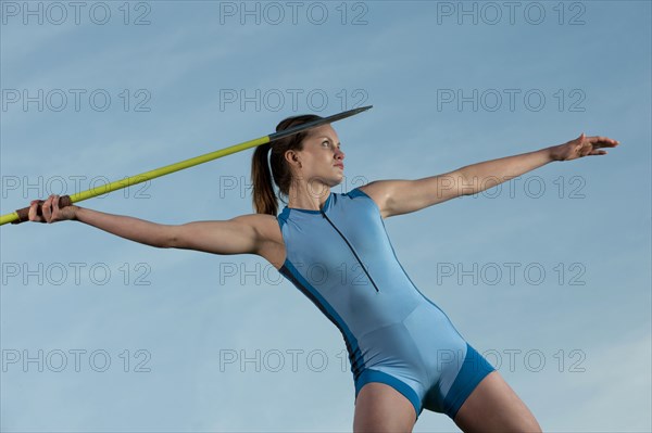 Caucasian athlete throwing javelin