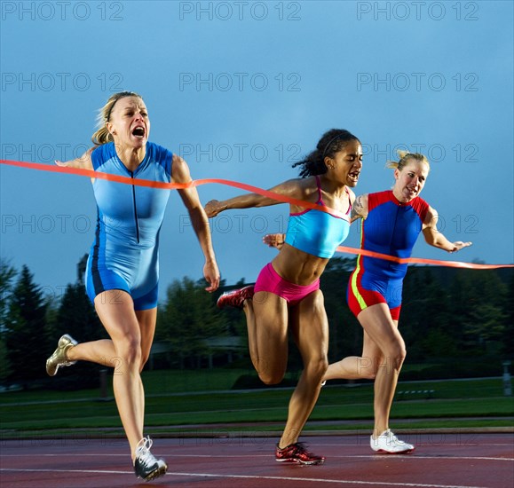 Runners crossing finish line in race