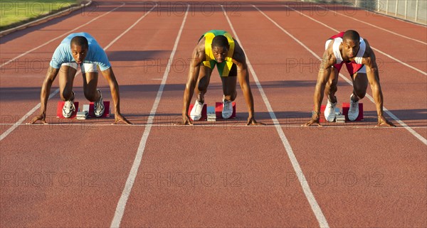 Black runners at starting block in race