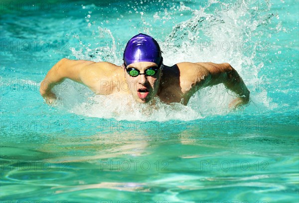 Caucasian swimmer training in swimming pool