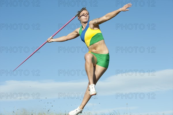 Caucasian athlete throwing javelin