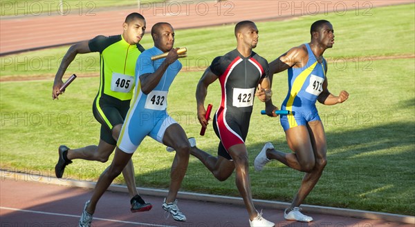 Relay racers running on track in race