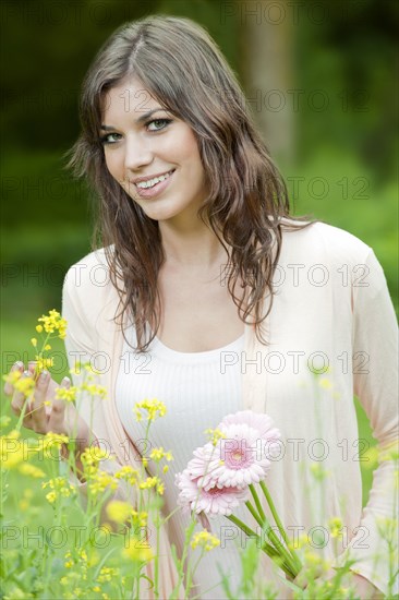 Caucasian woman holding flowers outdoors